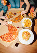 © kkgas/Stocksy - Anonymous people eating pizza