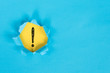 blue torn paper revealing exclamation mark on yellow paper. exclamation mark background concept