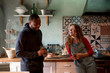 © Bisual Studio/Stocksy - Laughing couple at kitchen