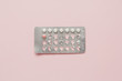 © Leandro Crespi/Stocksy - Contraceptive pills blister over pink background