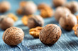 © Yakov - Walnuts and kernels on wooden backgound