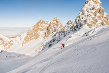 Man Skiing Off Piste In Mountains On A Bright Day