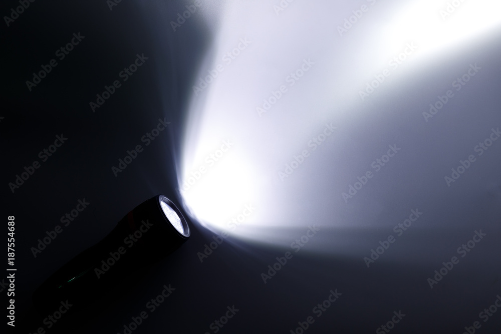 Beam of a flashlight on a white background, light and shadow concepts. - obrazy, fototapety, plakaty 