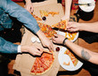 © kkgas/Stocksy - Anonymous people eating pizza
