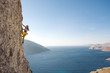 © RG&B Images/Stocksy - Female rock climber ascending on steep rock wall