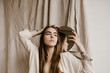 © Nicole Mason/Stocksy - young stylish woman holding circular mirror next to face
