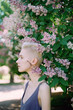 © Lyuba Burakova/Stocksy - Woman standing near tree during spring