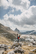 © Boris Jovanovic/Stocksy - Woman doing gymnastics exercise while standing on the rock in the mountain