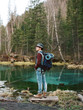 © Alexandr Ivanets/Stocksy - Tourist at transparent lake