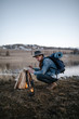 © Alexandr Ivanets/Stocksy - Male tourist making campfire