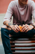 © Leandro Crespi/Stocksy - Young man eating burger on the street