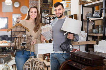 Wall Mural - Satisfied couple demonstrating their buies in shop