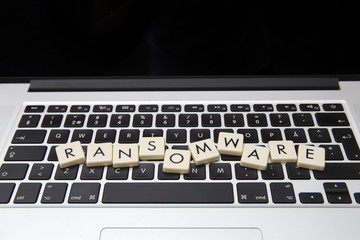 Wall Mural - ransomware text written with letters on a modern laptop. information security threat concept image.