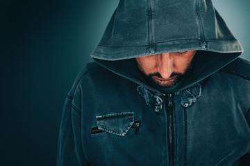 Wall Mural - Serious portrait of adult man with hoodie