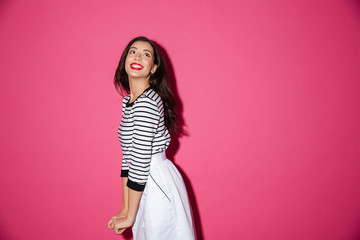 Wall Mural - Portrait of a smiling woman posing while standing