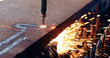 © NDABCREATIVITY - Oxygen torch cuts steel sheet. CNC gas cutting machine. Bright sparks