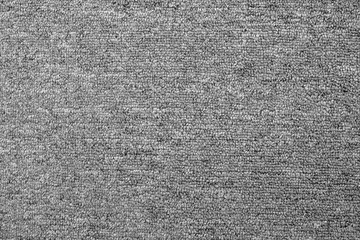 close up of monochrome grey carpet texture background from above