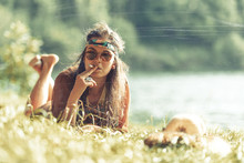Pretty Free Hippie Girl Smoking On The Grass - Vintage Effect Photo Effect.