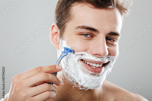 Photo Of Masculine Brunette Guy With Dark Short Hair Shaving His