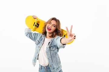 Poster - Happy woman in denim clothes with skateboard having fun