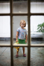Girl With Watering Can Standing Stubbornly Still