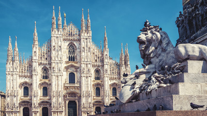 Sticker - Milan Cathedral and monument with lion statue under blue sky, Italy