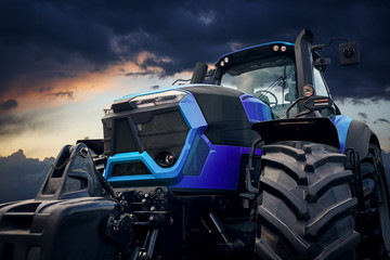 Poster - Powerful tractor against a stormy sky