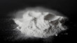DRUGS: Man does a lines of heroin by plastic card - Close up. Plastic card and white powder. Lines and pile of cocaine on wooden table. Macro