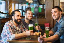 Friends Taking Selfie With Green Beer At Pub