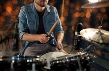 Male Musician Playing Drum Kit At Concert