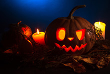 Halloween Pumpkin Lantern With Dry Leaves With Burning Candles