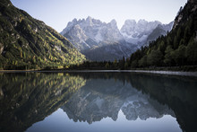 Scenic View Of Calm Lake Amidst Mountains Against Sky