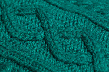 Macro color image of green knitted texture.