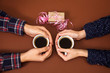 © NataliAlba - man woman holding cups coffee hands gift valentine day brown background vintage love story box