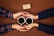 © NataliAlba - man woman holding cups coffee hands gift valentine day brown background vintage love story box