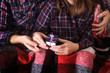 © NataliAlba - Top view picture male female hand gift box Christmas family celebration hands plaid gift valentine love