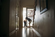 © Cavan Images - Siblings playing by door at home