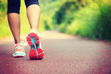 Wall Mural - young fitness female runner legs ready for run on forest trail .