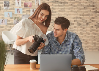 Wall Mural - Two young photographers working in office