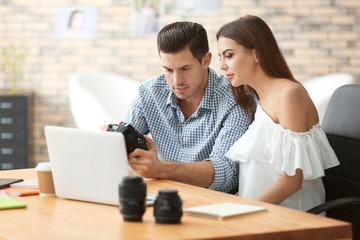 Canvas Print - Young photographers with camera in office