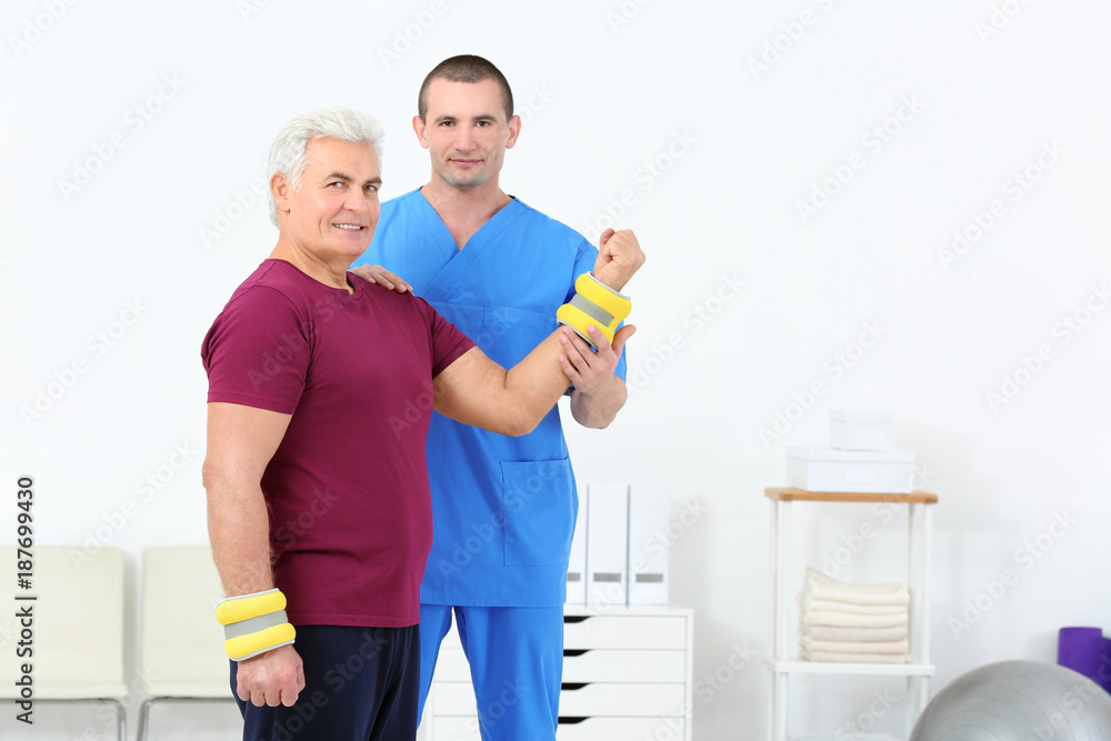 Physiotherapist working with patient in rehabilitation centre