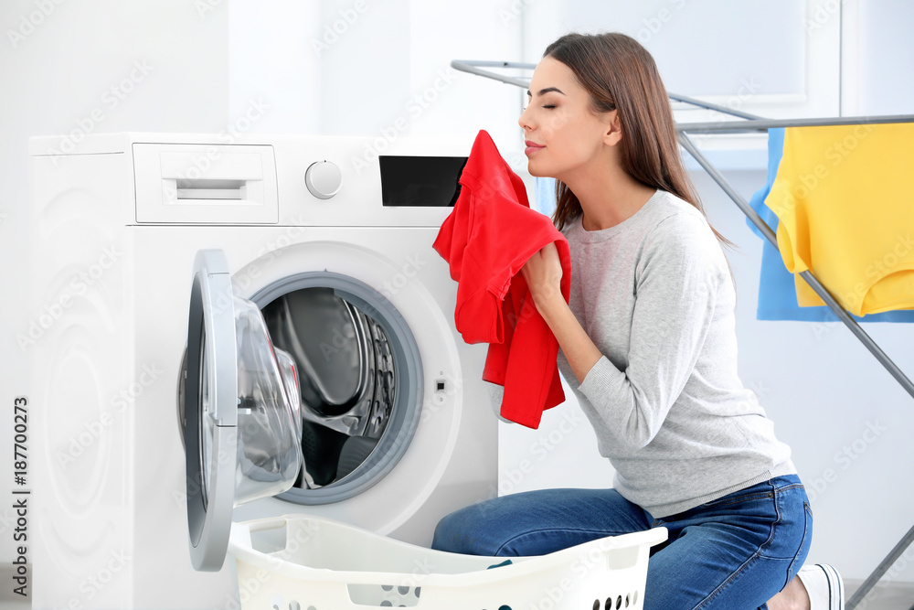 Young woman doing laundry at home