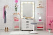 © Africa Studio - View of makeup room with decorative cosmetics and tools on dressing table