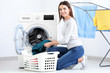 © Africa Studio - Young woman doing laundry at home