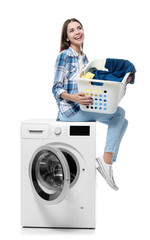 Wall Mural - Young woman doing laundry on white background