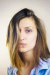 © lavrenkova - Portrait of young beautiful woman with no makeup and messy hair covering one side of her face. Film style