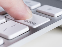 Finger Is Pressing Delete Key Of Computer Keyboard