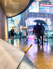 Sticker - NEW YORK CITY - JUNE 8, 2013: Tourists walk in Times Square on a rainy night. New York attracts 50 million people every year