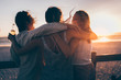© Criene Images - Groupf of female friends hugging each other in sunset