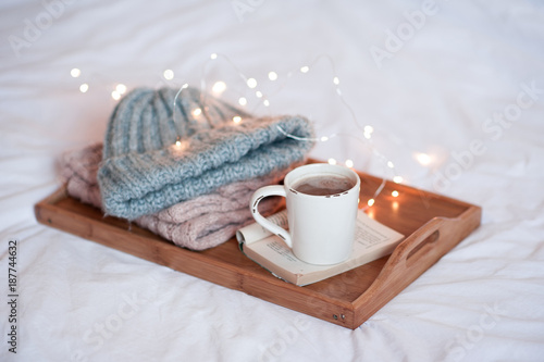 Winter Season Cup Of Coffee With Open Book And Knitted Clothes On